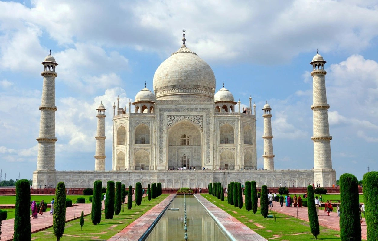 Symmetrical view of the white marble Taj Mahal in Agra during sunrise