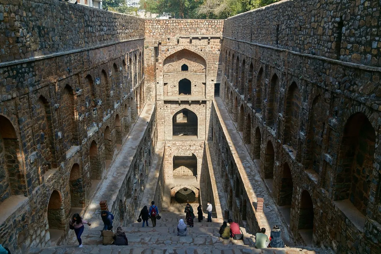 Deep symmetrical stone steps descending into the historic Agrasen Ki Baoli stepwell in Delhi