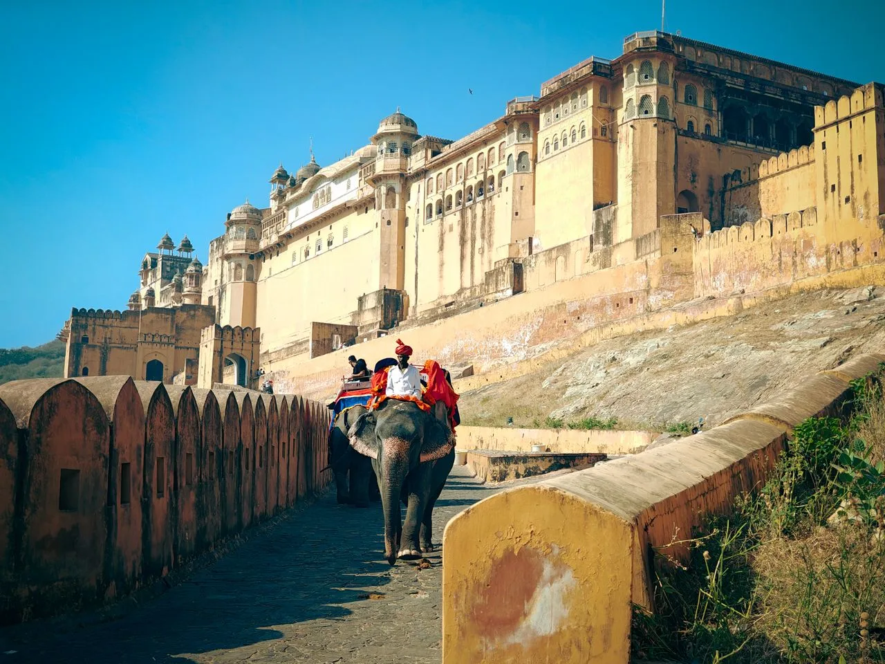 Grand entrance facade of Amber Fort overlooking Maota Lake in Jaipur