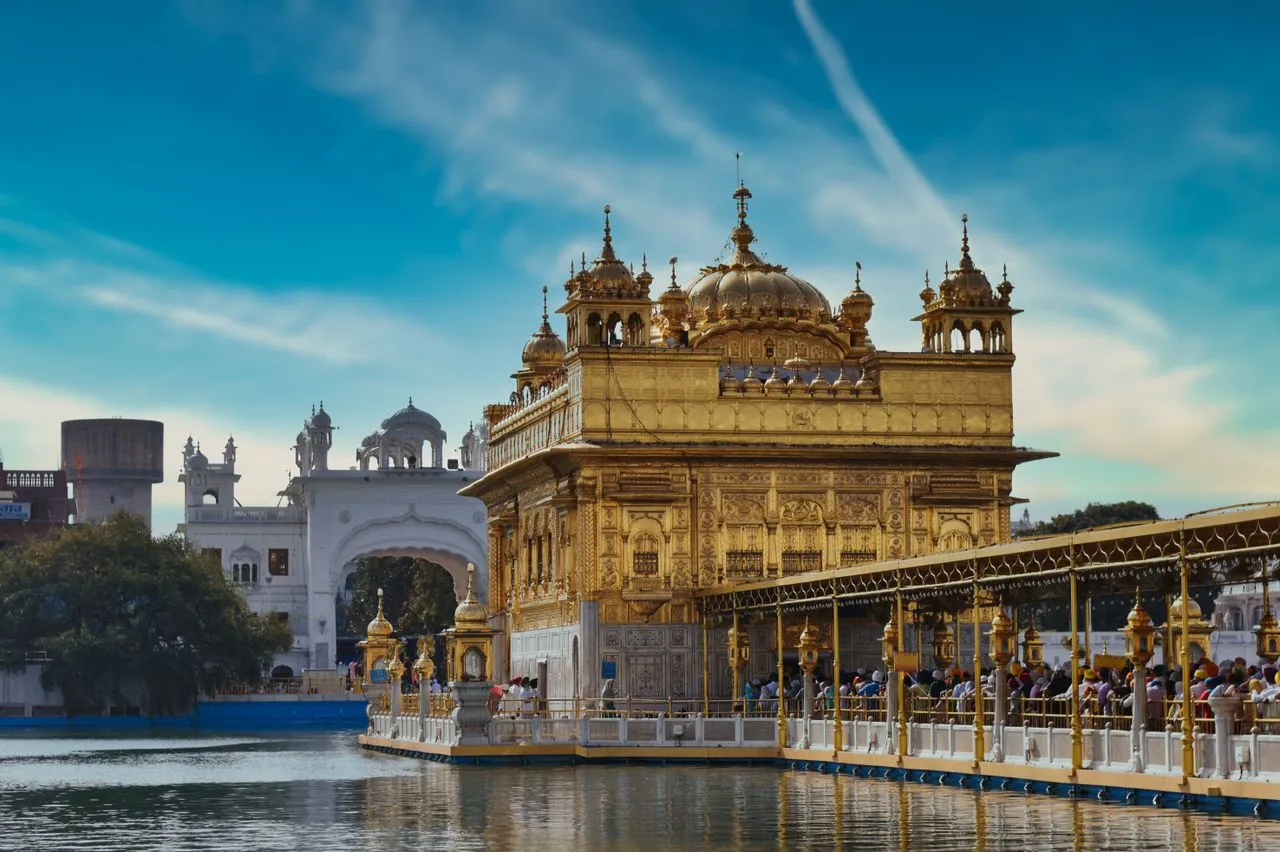 Illuminated Golden Temple complex reflected in the holy water tank in Amritsar Punjab