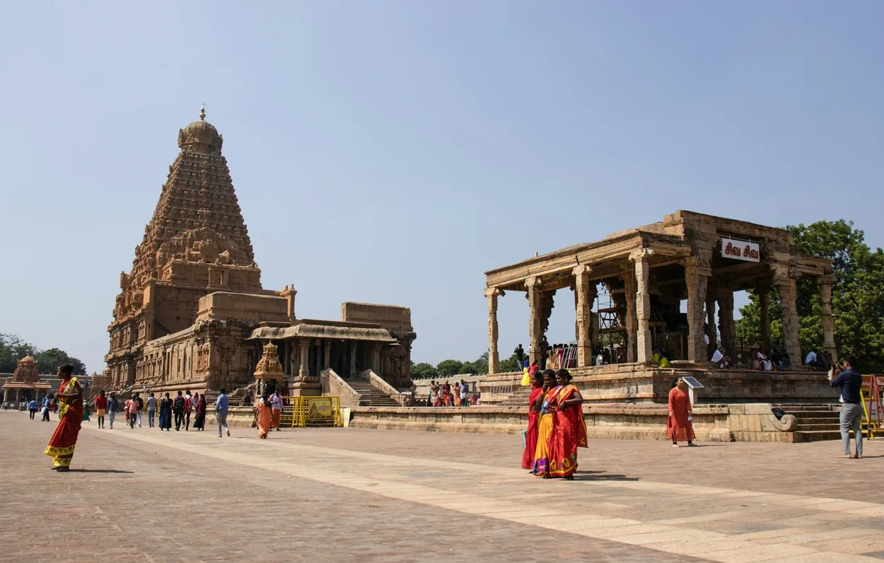 Wide view of the grand Brihadisvara Temple vimana tower and courtyard with visitors, a UNESCO World Heritage site in Thanjavur Tamil Nadu