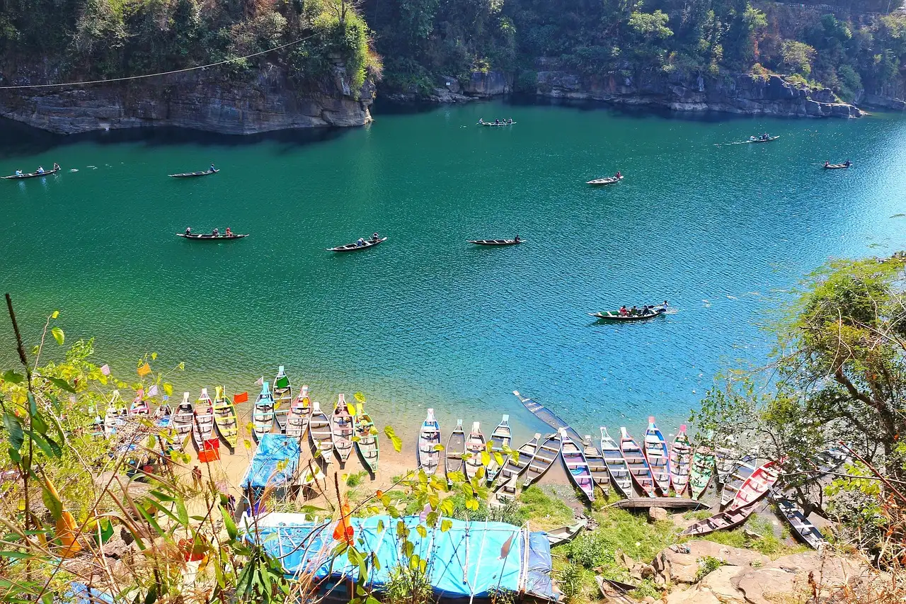 Wooden boat floating on crystal clear Umngot river in Dawki Meghalaya