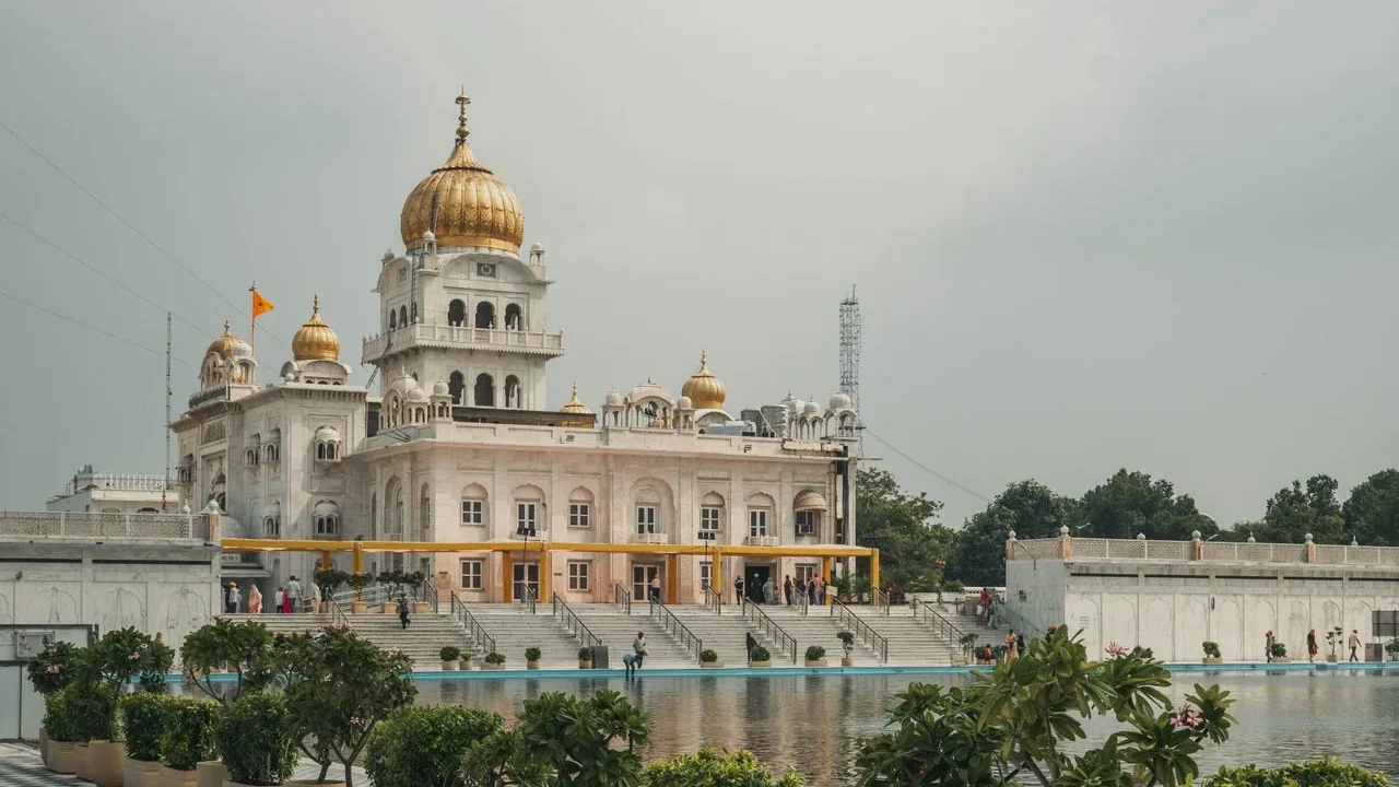 Collage of top Delhi tourist attractions featuring Qutub Minar, Red Fort, Lotus Temple, and India Gate