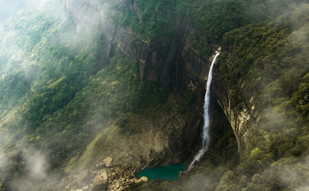 Lush green waterfalls in Meghalaya during monsoon season, a top monsoon destination in India