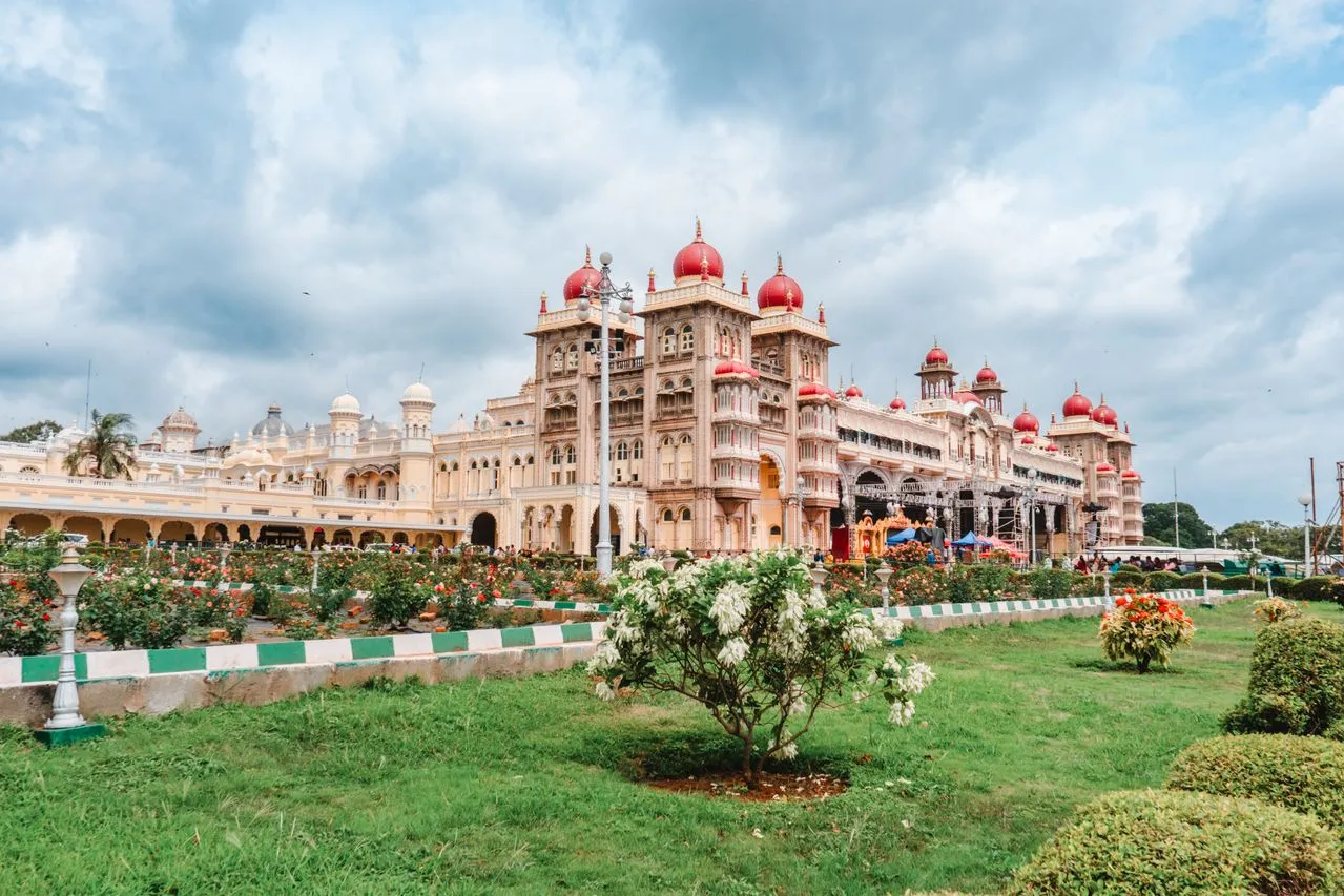 Grand Mysore Palace lit up with golden lights during evening celebrations in Mysuru