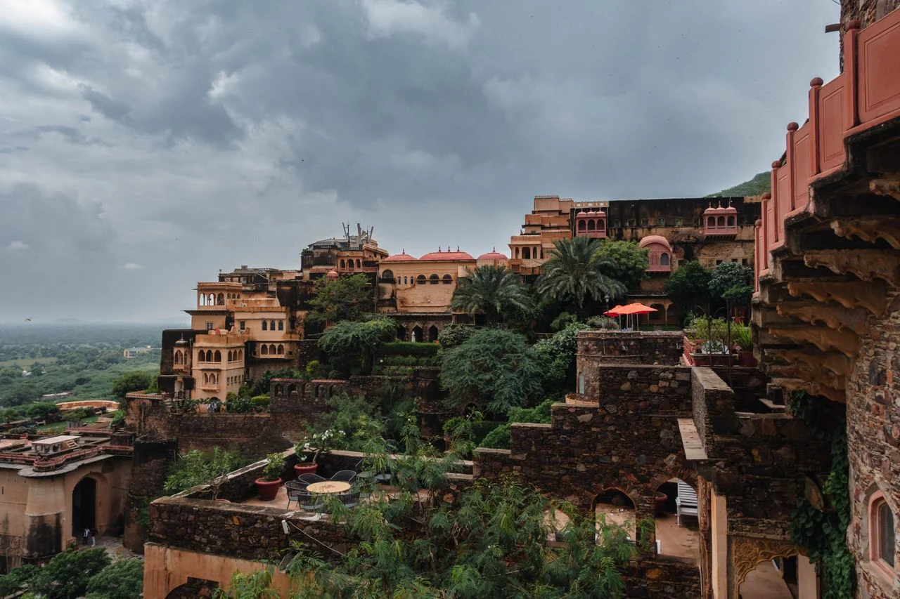 Exterior view of the 15th-century Neemrana Fort Palace lit up at sunset near Delhi