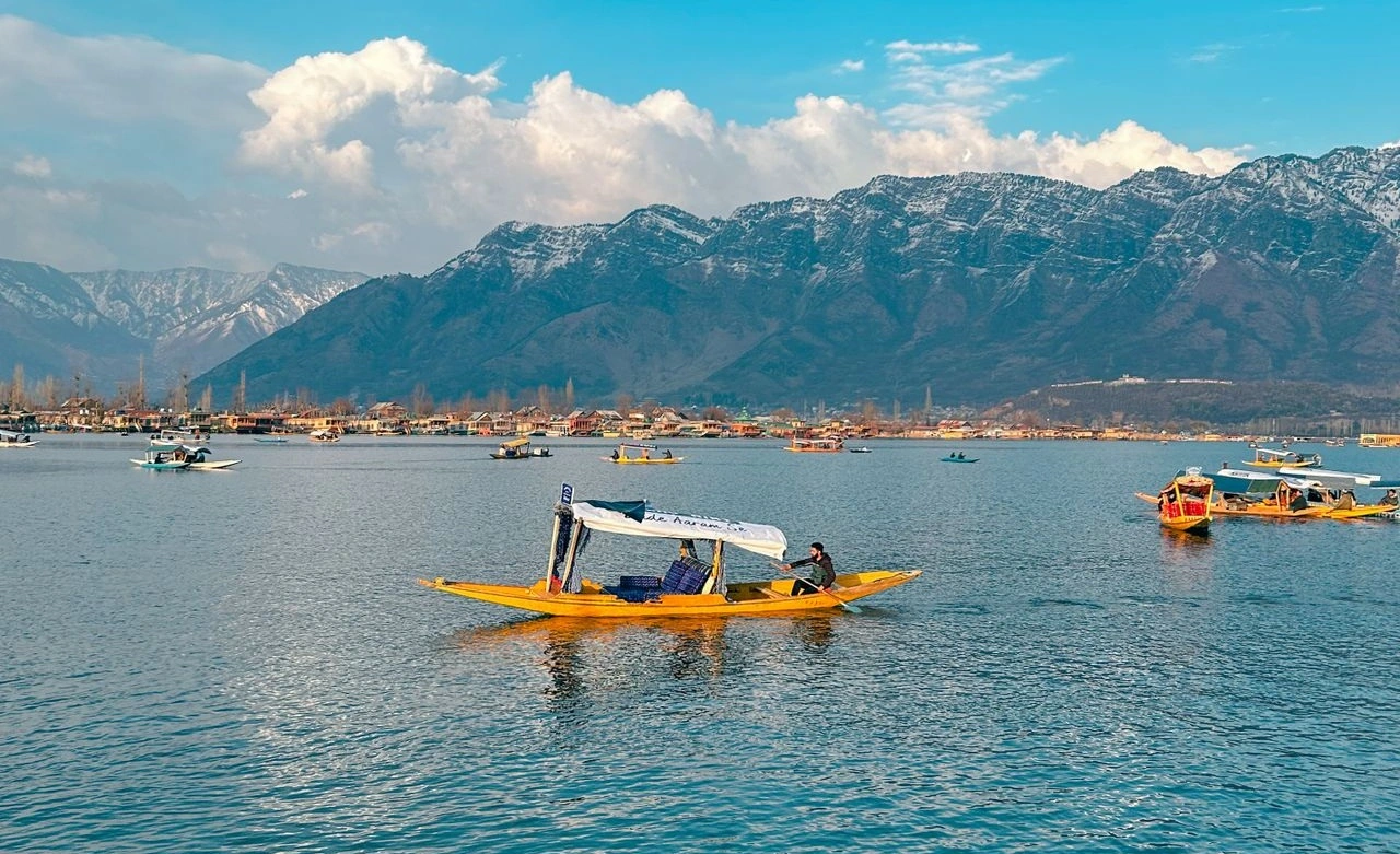 Traditional Shikara boat floating on calm waters of Dal Lake in Srinagar Kashmir