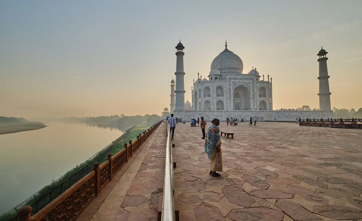 Sunrise view of the Taj Mahal reflecting in the pool in Agra