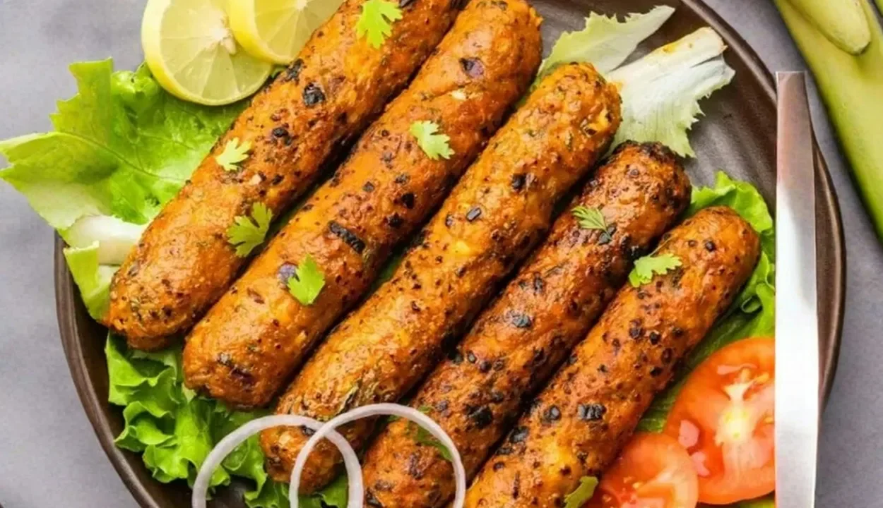Plate of grilled Mughlai Seekh Kebabs served with lemons and onion rings in Agra