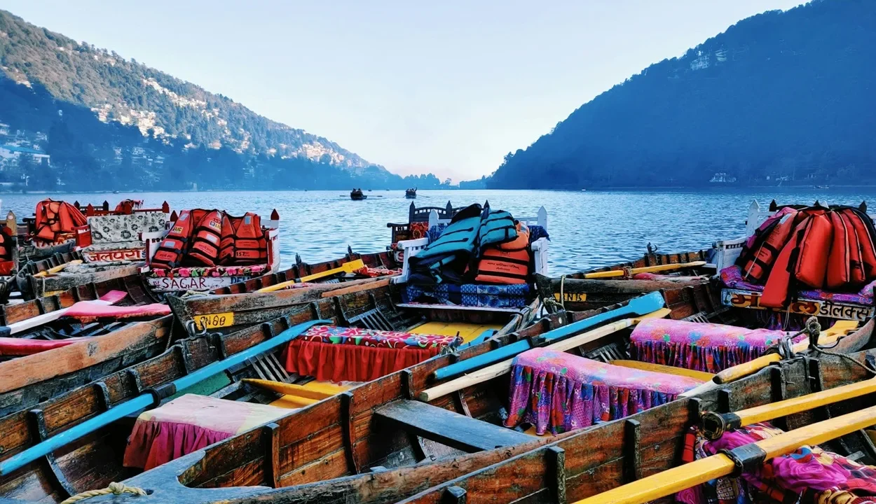 Vibrant wooden rowboats lined up on Naini Lake showcasing top things to do in Nainital.